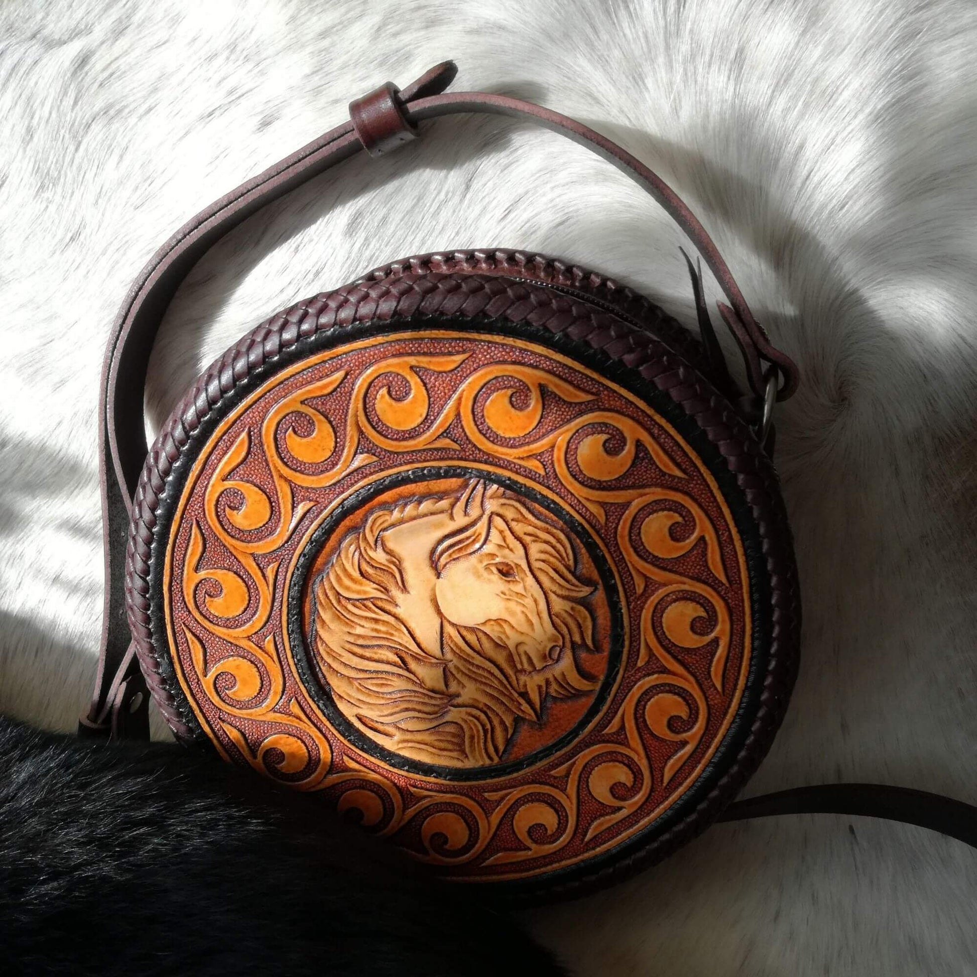 Top view of Equina leather crossbody bag showing tooling and strap
