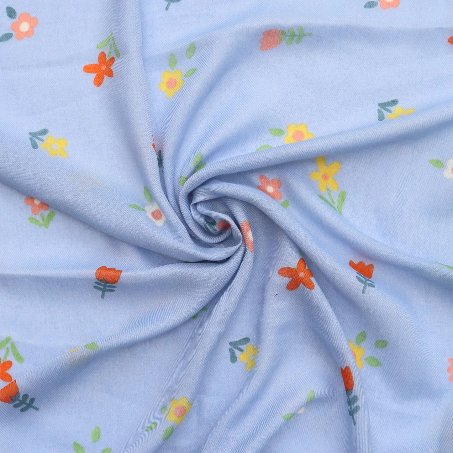 Soft light blue scarf with floral pattern in orange yellow and green swirled to show fabric texture