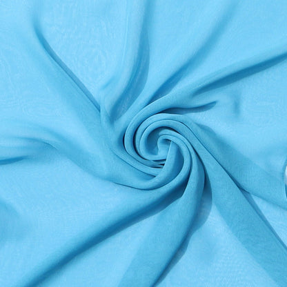 Light blue chiffon scarf close-up – delicate fabric swirl, lightweight summer-to-winter scarf from Aurora’s Array, perfect pastel accessory