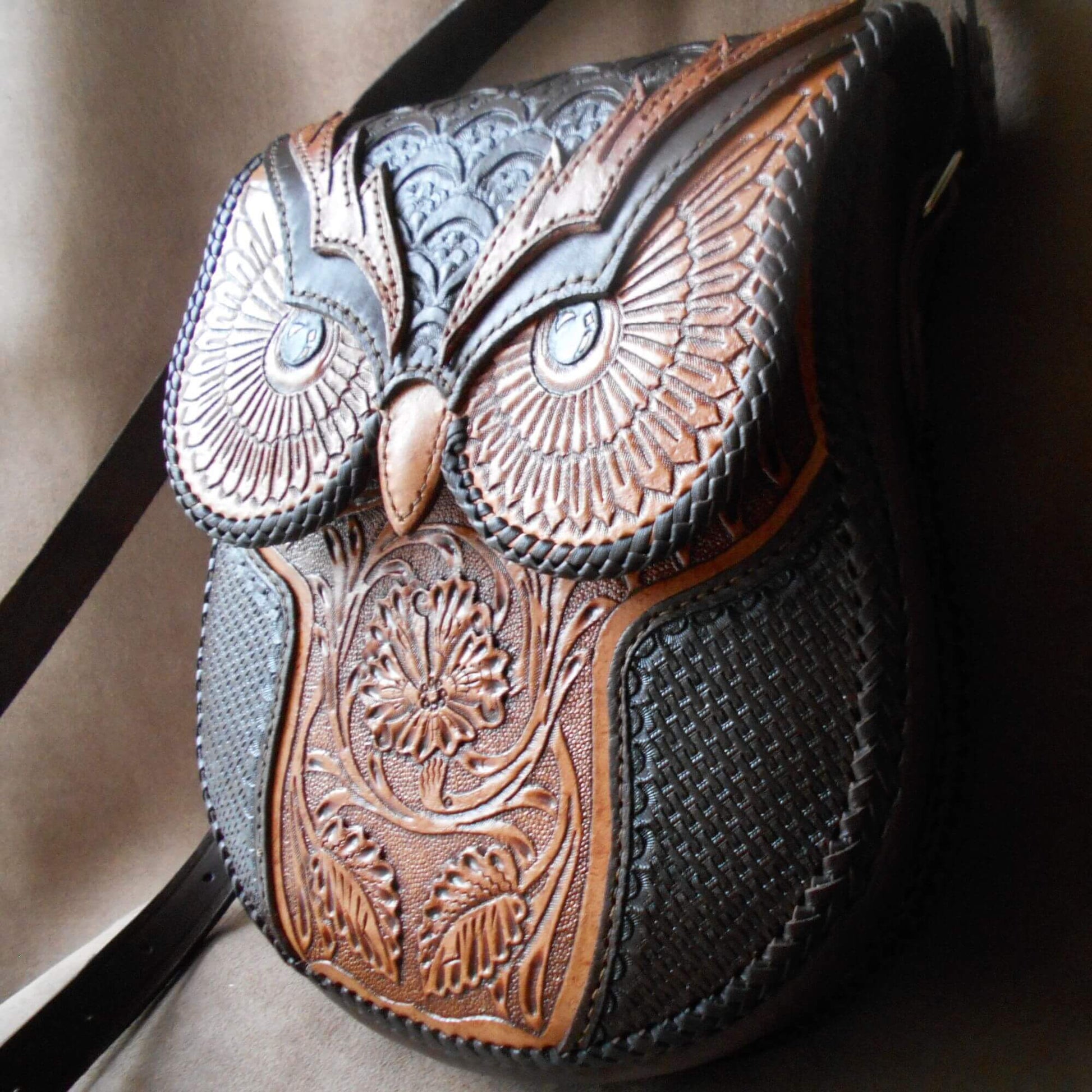 Angled view of owl-tooled leather bag with adjustable strap – Nox