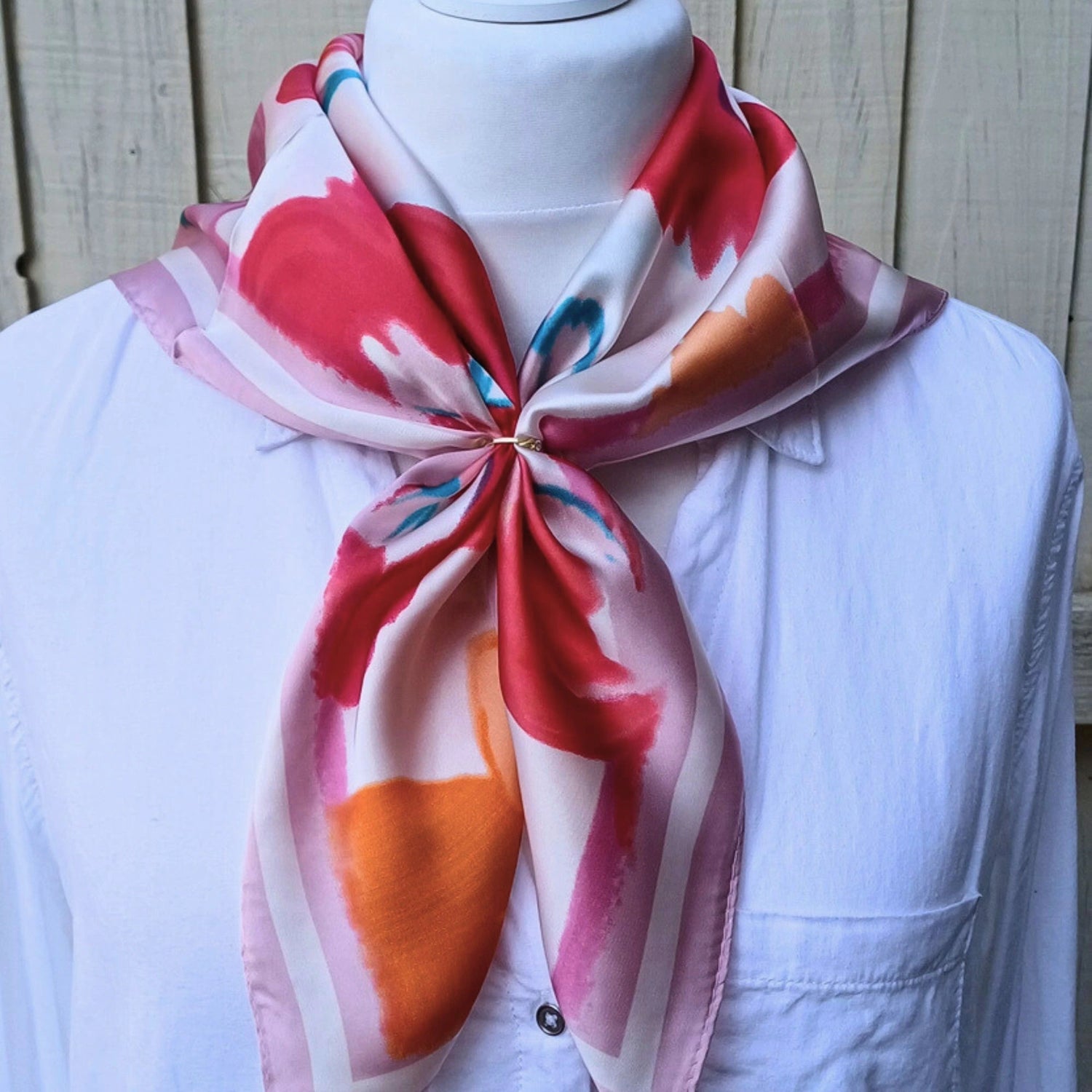 Pink orange floral silky feel square scarf tied on mannequin