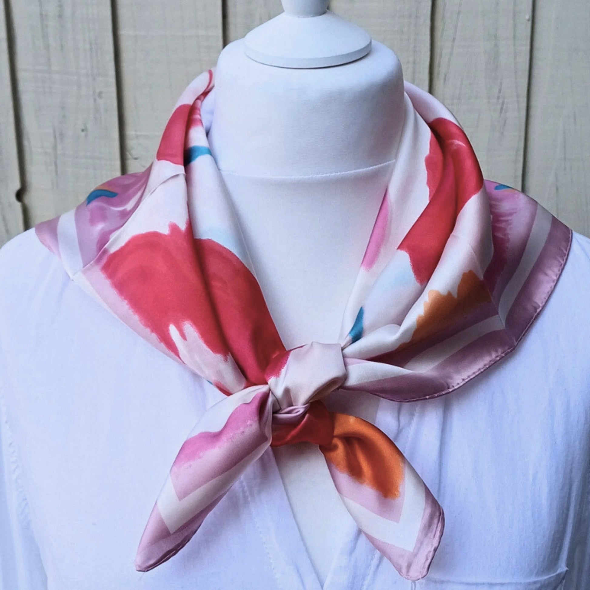 Close up of pink orange floral silky feel square scarf fabric pattern