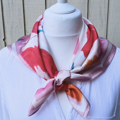 Close up of pink orange floral silky feel square scarf fabric pattern