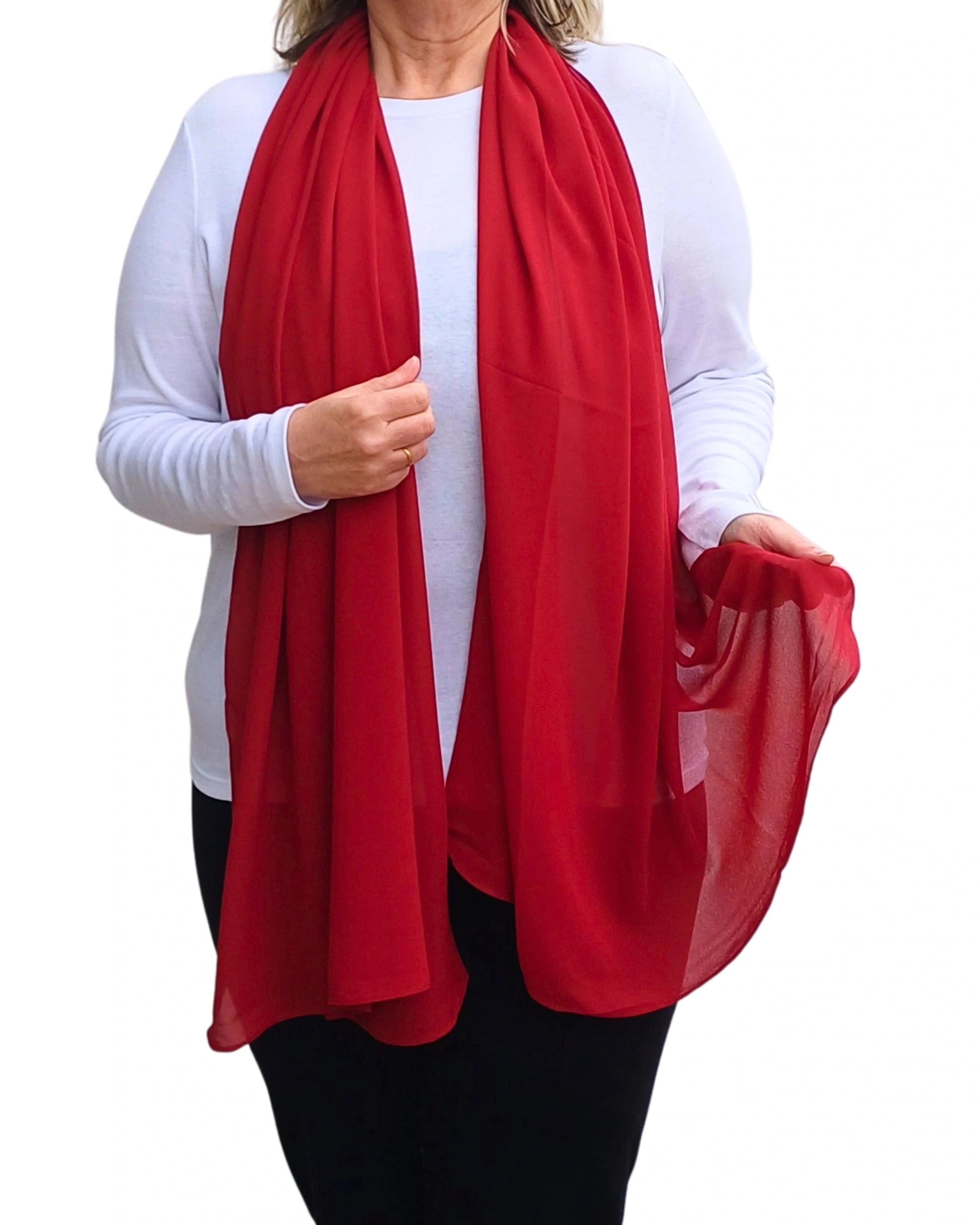 Red chiffon scarf shown on model over white top with sheer drape held in hand