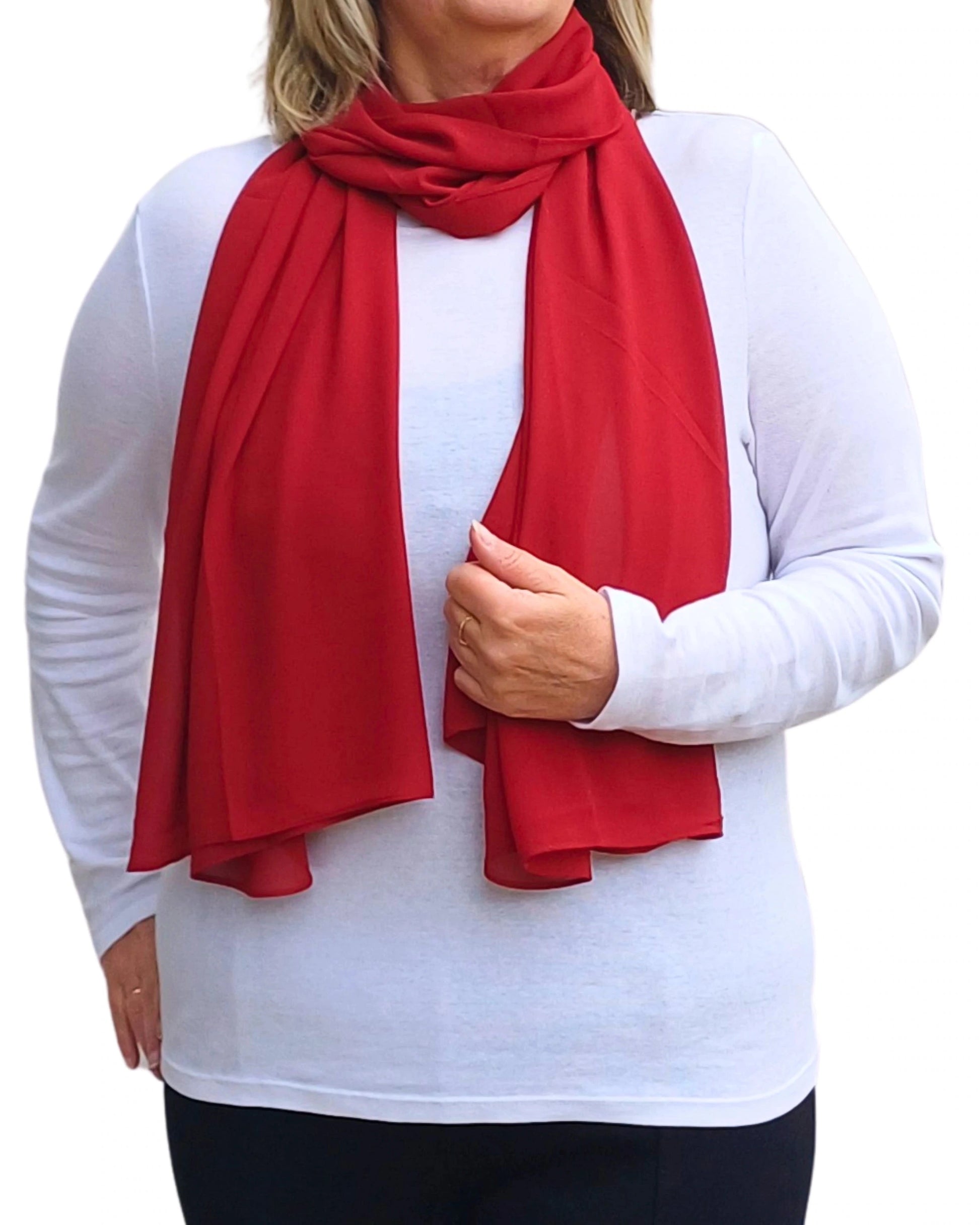 Red chiffon scarf draped on model soft georgette accessory styled over white top