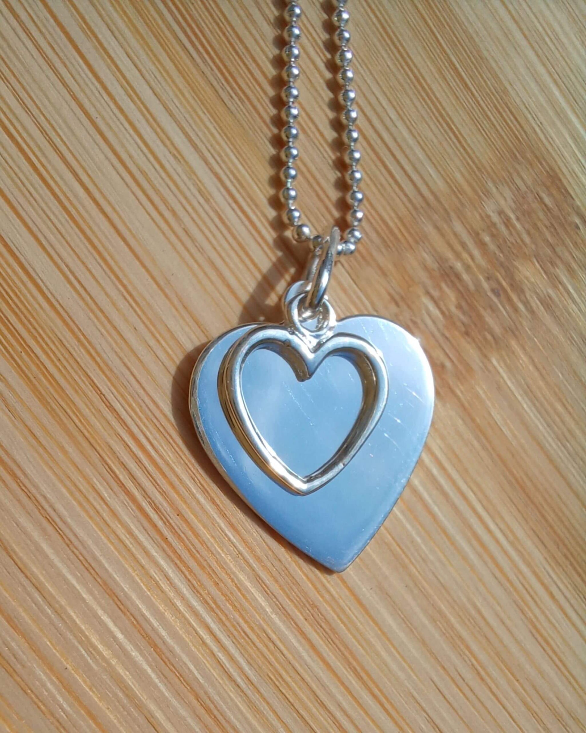 Sterling silver double heart pendant necklace on chain, plain and outline design