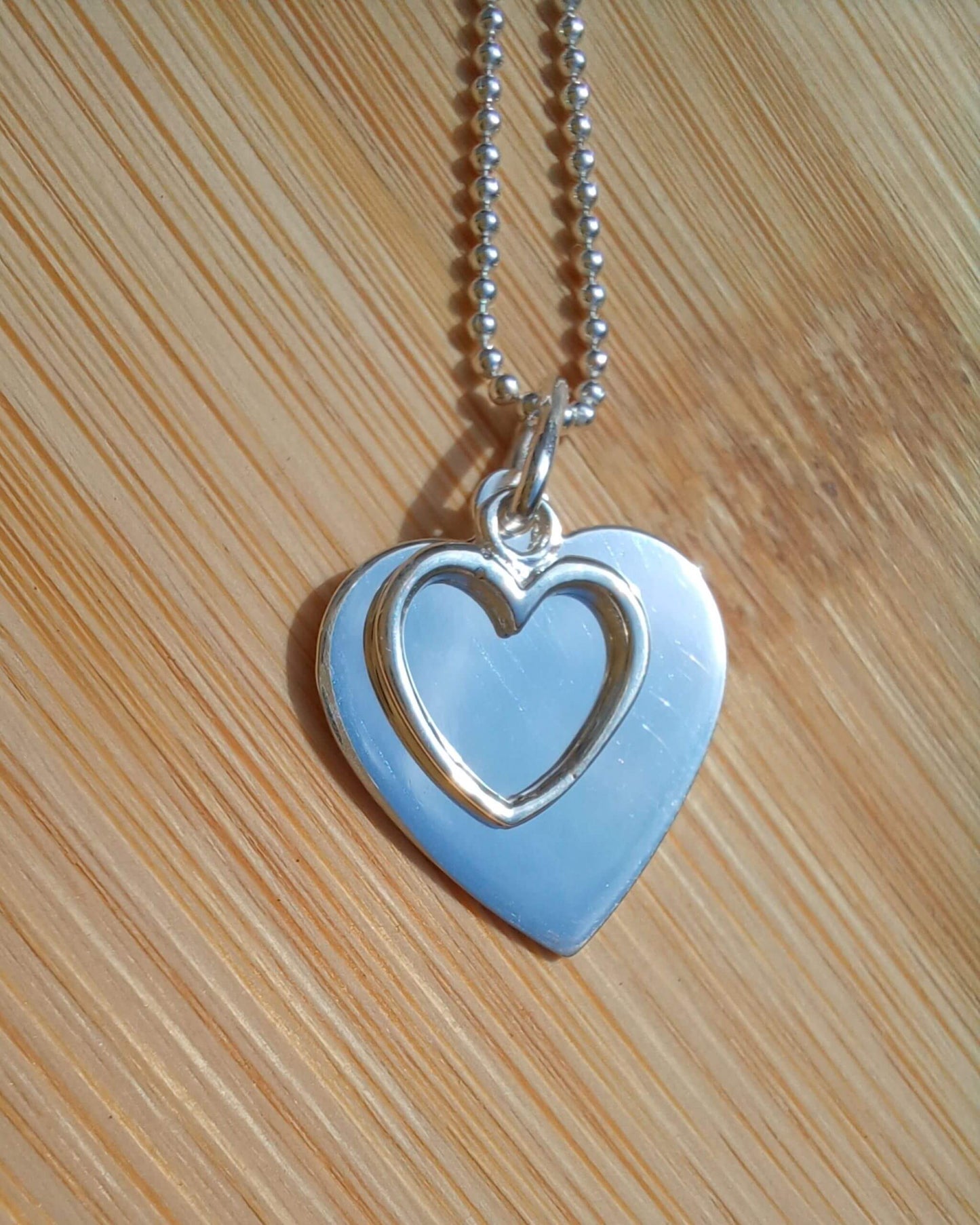 Sterling silver double heart pendant necklace on chain, plain and outline design