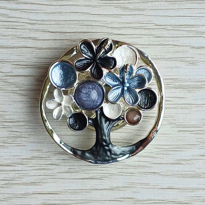 Blossom tree magnetic brooch in grey decorative painted finish on a wooden surface.