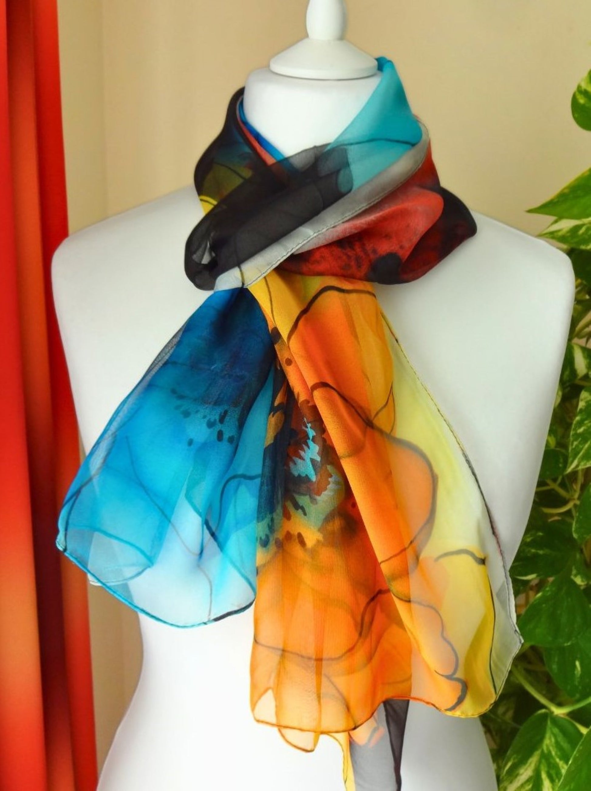 Multicolour chiffon scarf with vivid flower print in orange, blue and black tones