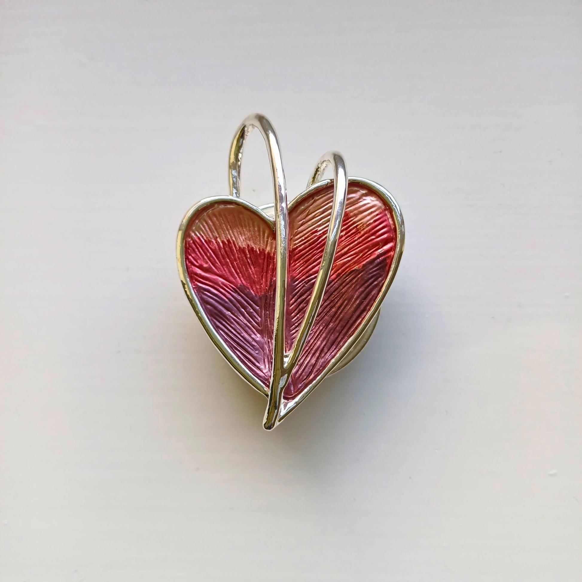 wrapped heart magnetic brooch red on wooden background